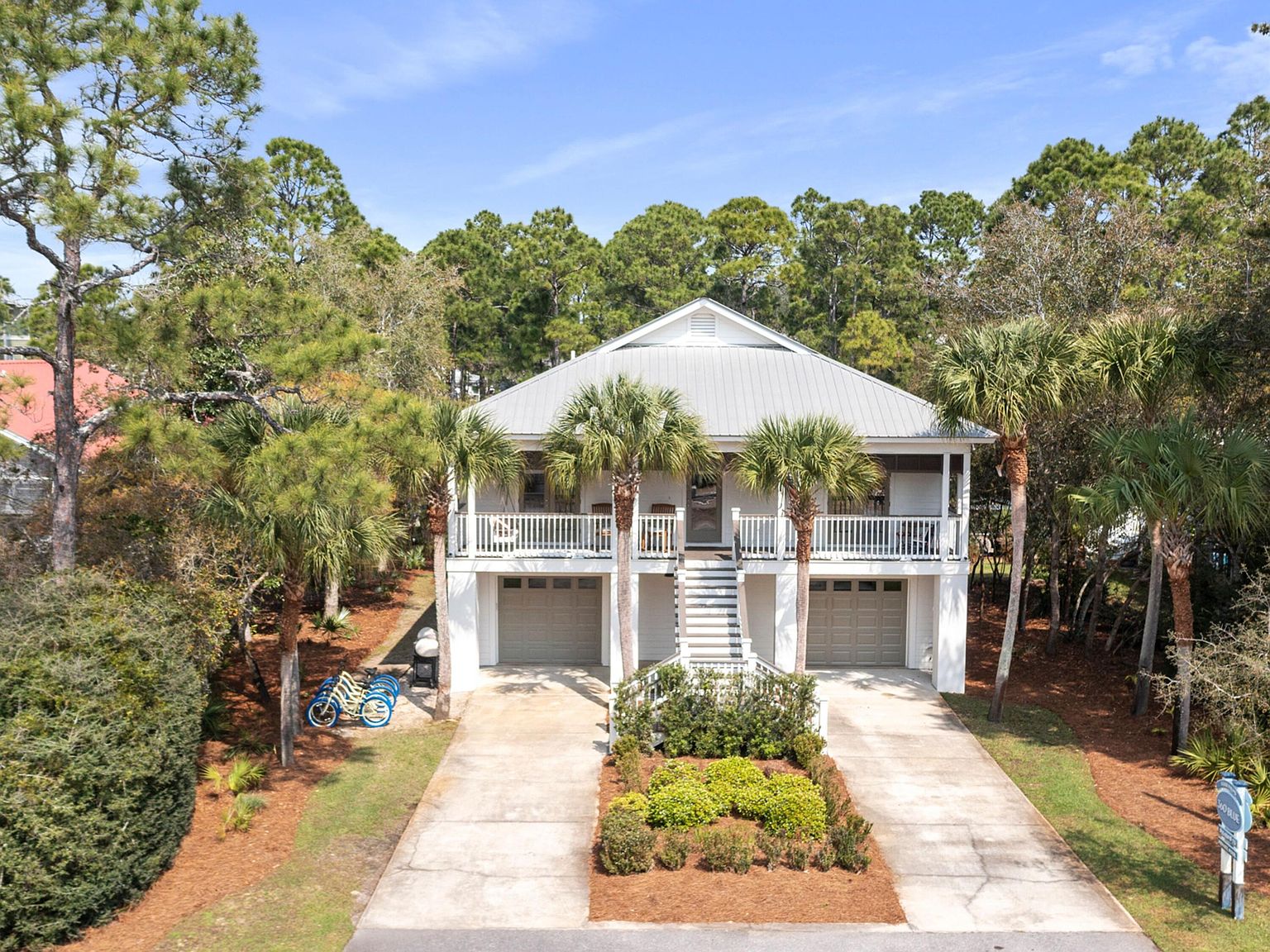 Front elevation of 499 Lakeview Drive showing the two-story coastal facade and twin garages