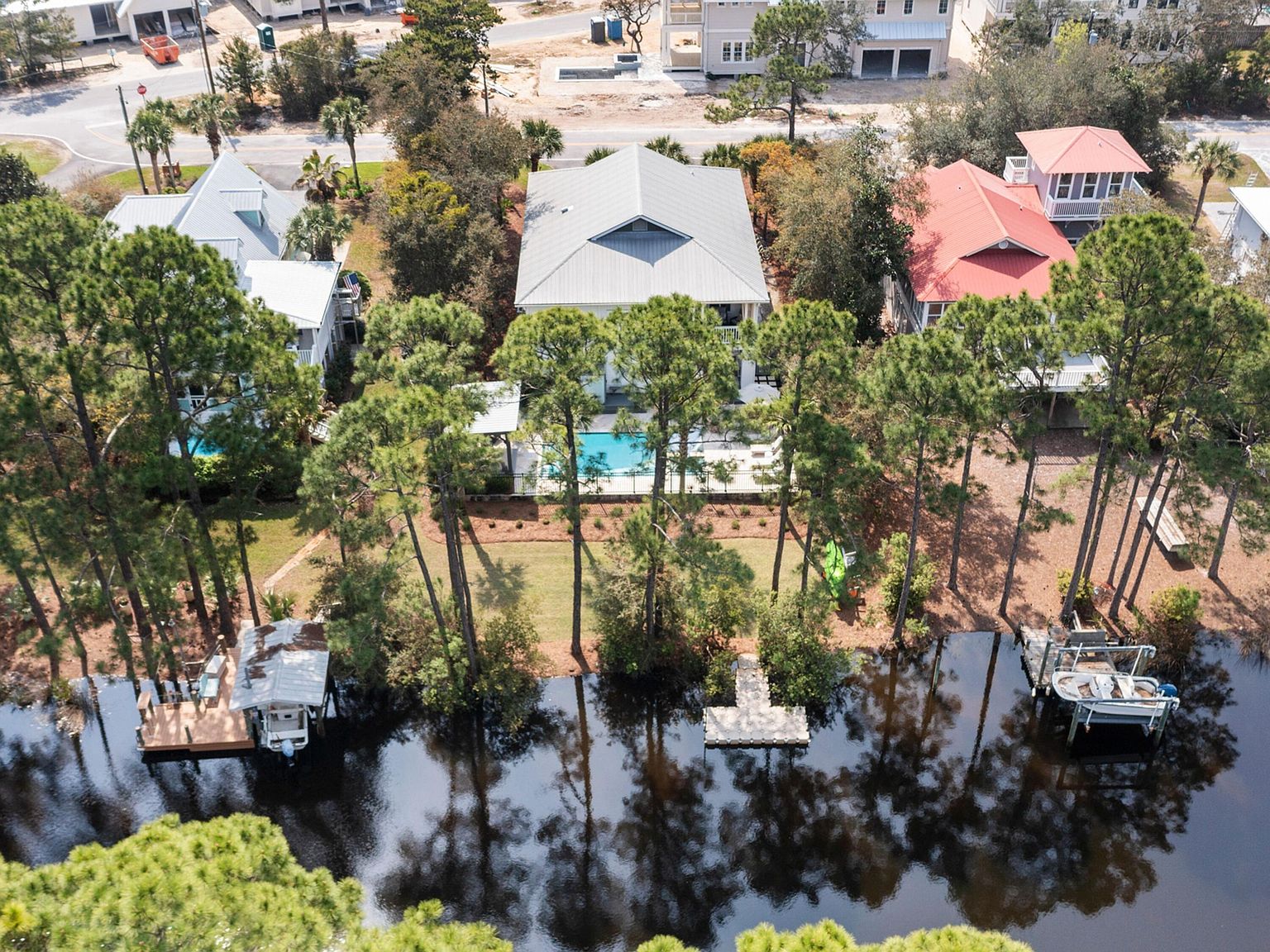 Aerial view of the canal frontage with private dock and neighboring docks along Eastern Lake